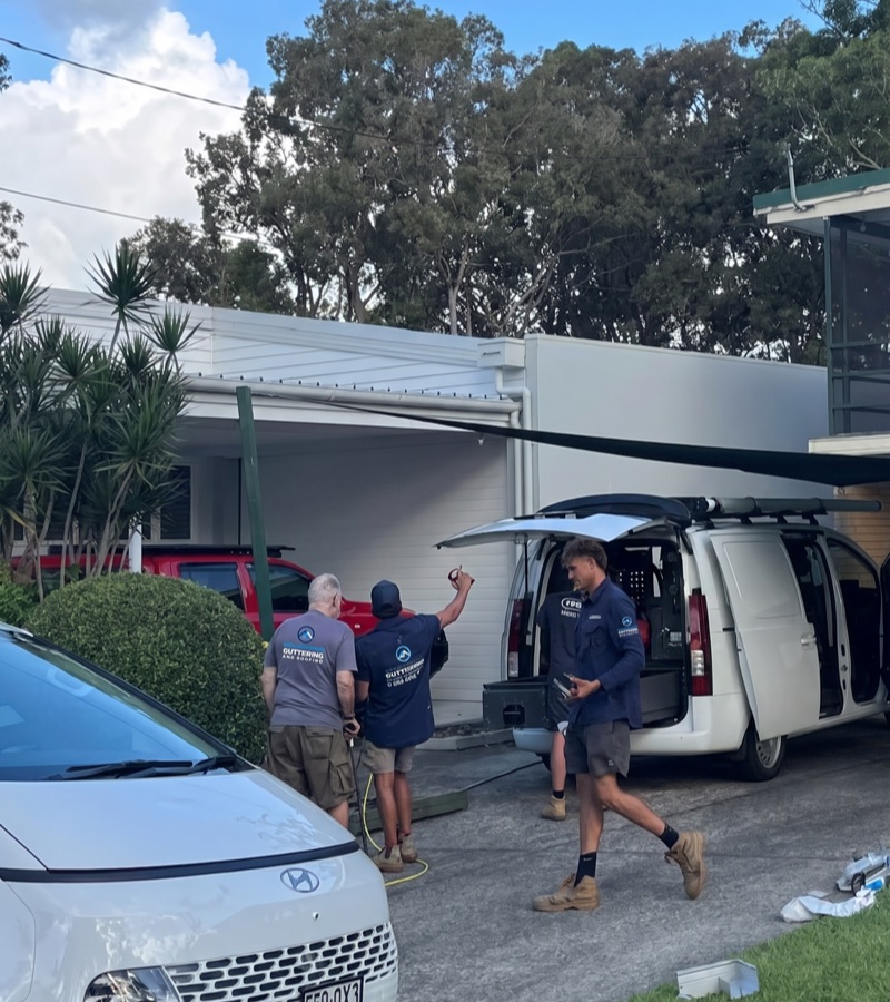 Roofing team working on a roof repair and replacement job
