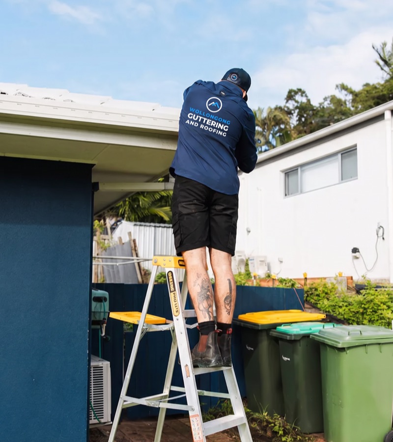 Roofer repairing fascia and flashing